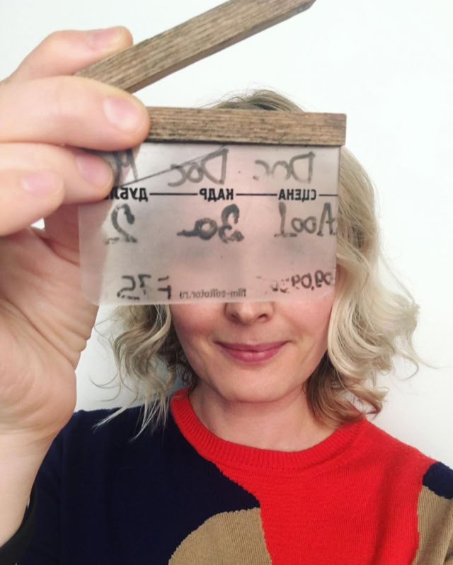 Dasha holding a film slate